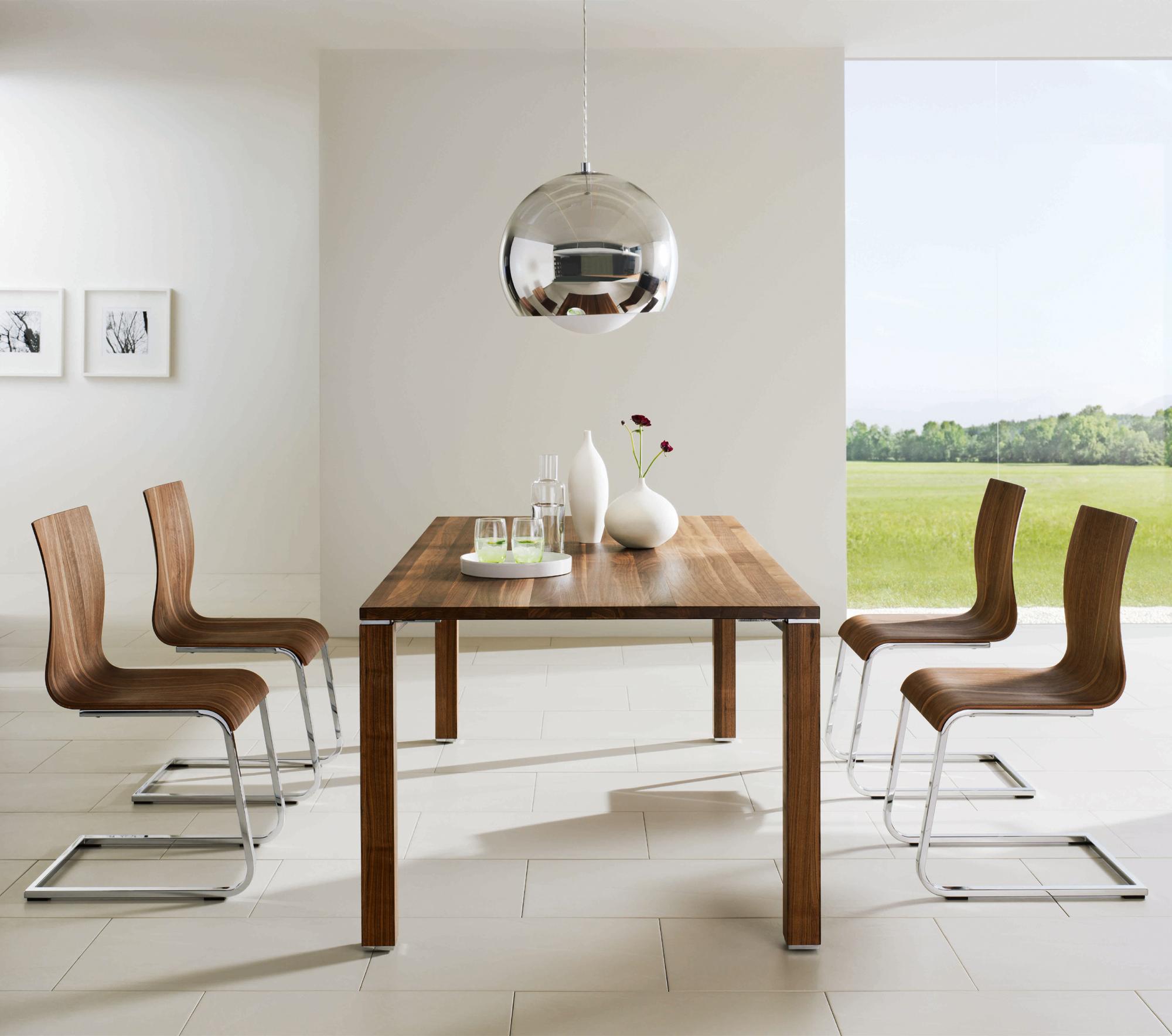 This picture shows a table and four chairs made of wood